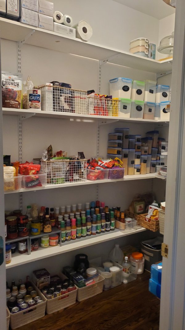 After: pantry supplies grouped on clear shelves with more open floor space